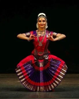 best-classical-dance-schools-students-practice (2) Bharatanatyam dancer performing a traditional posture on stage during classical dance classes in Kannur.