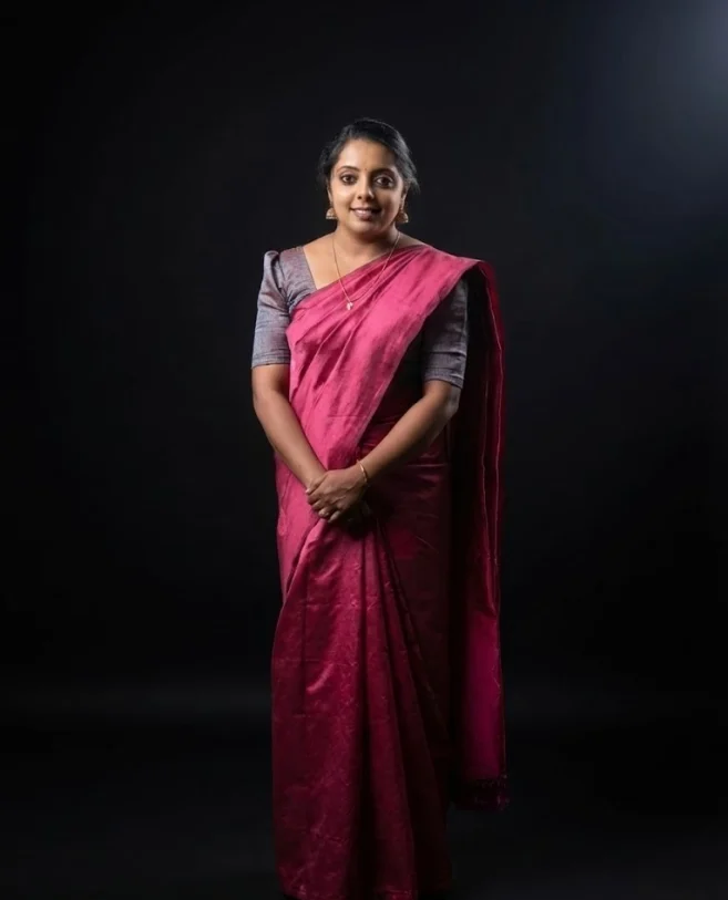 Instructor in traditional saree posing for a portrait at classical dance classes in Kannur.